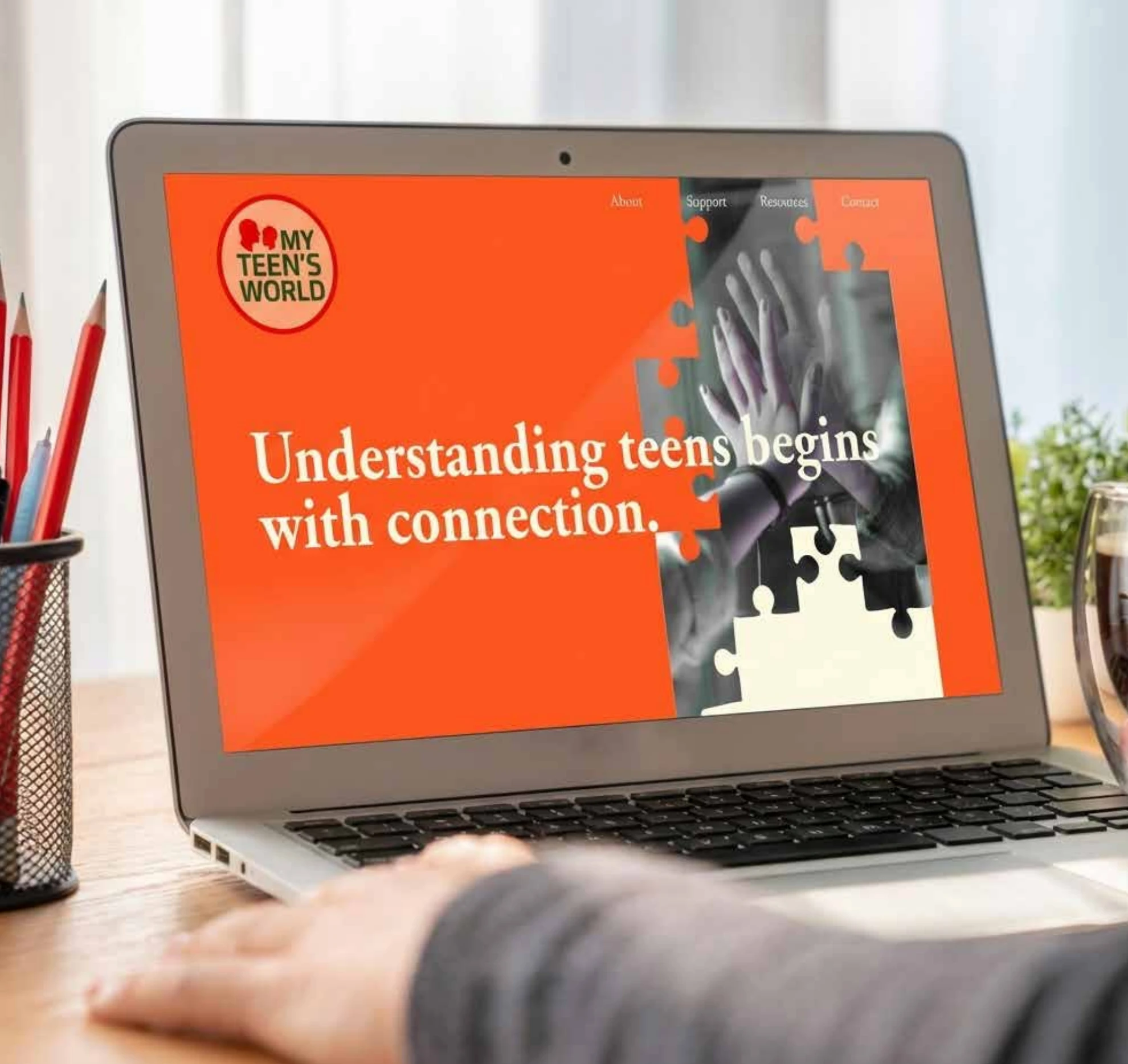 My Teen's World website homepage shown on a laptop